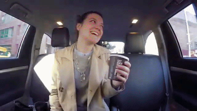 Modern home office setup with a monitor, ergonomic chair, keyboard, and indoor plants near a window with blinds.