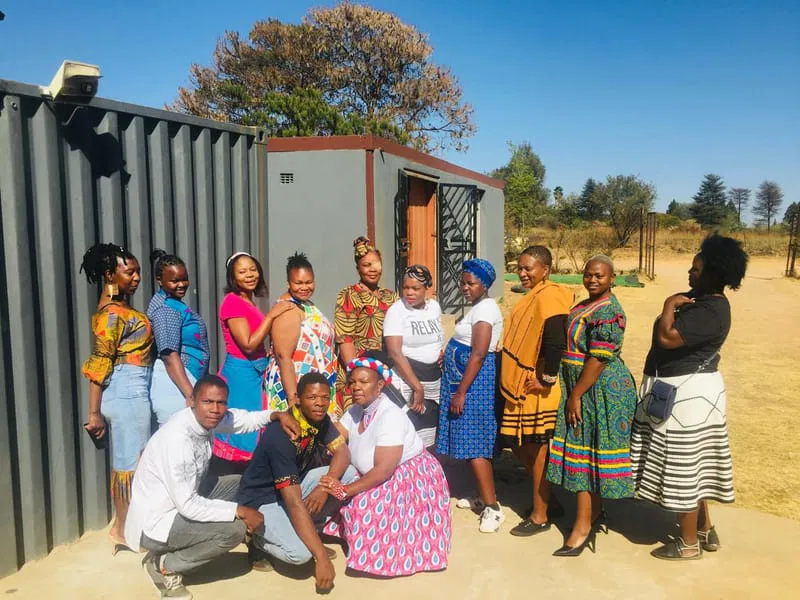Close-up of a dark green leaf showing its textured surface and central vein against a muted background.