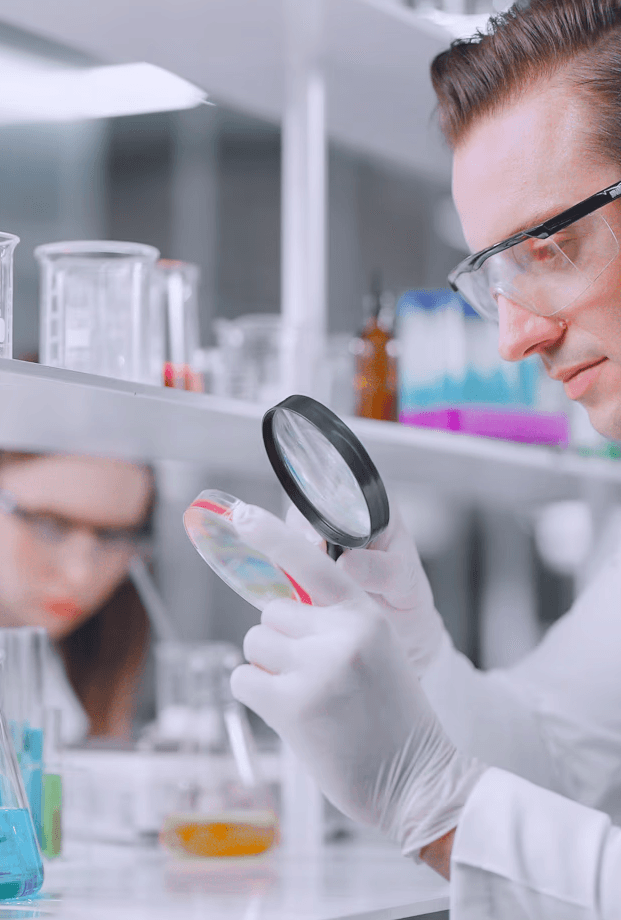 a person in a mask and gloves using a laptop