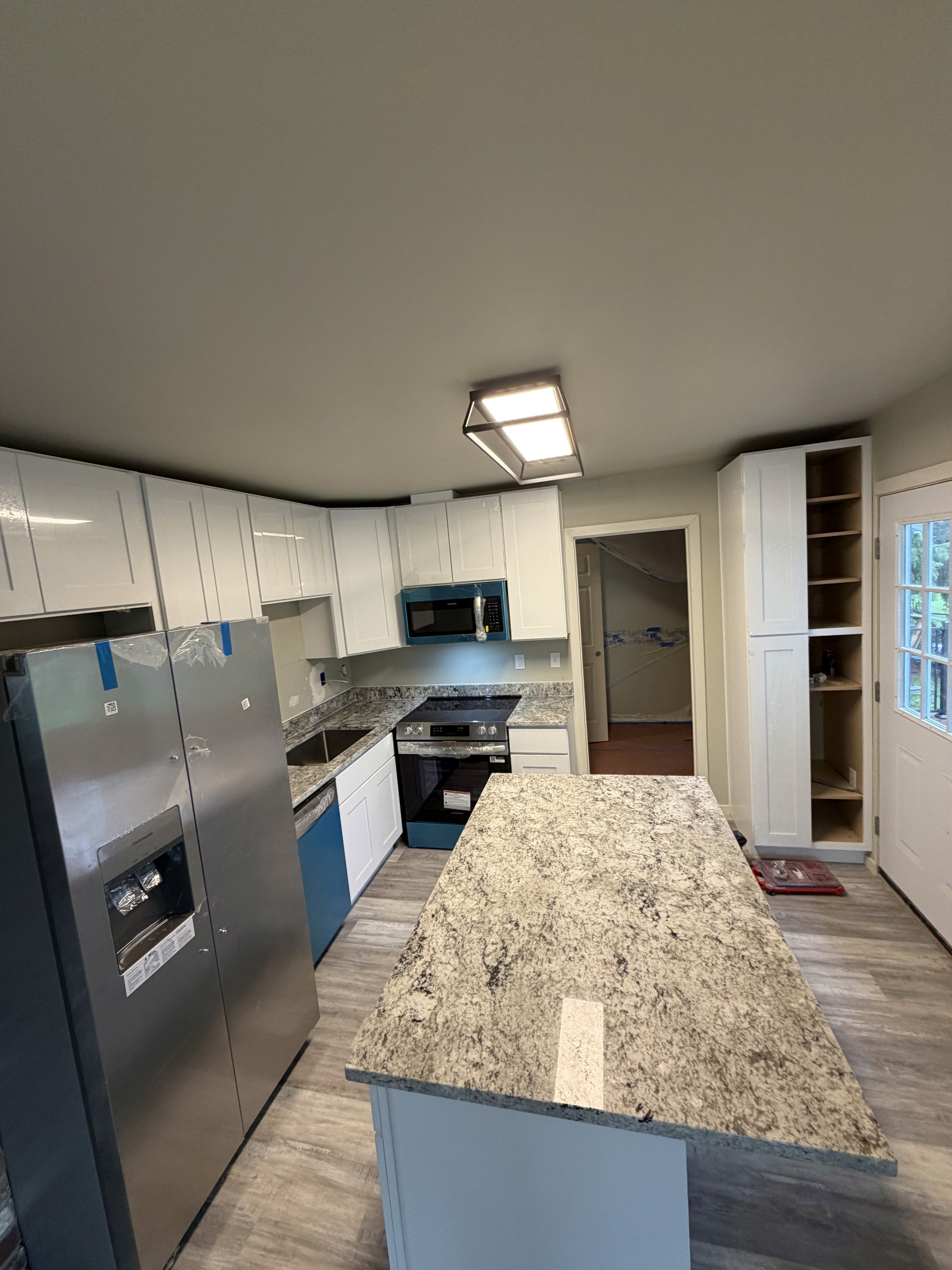 Modern bathroom featuring wooden cabinetry, a bathtub, a sleek sink, and natural light from a window.