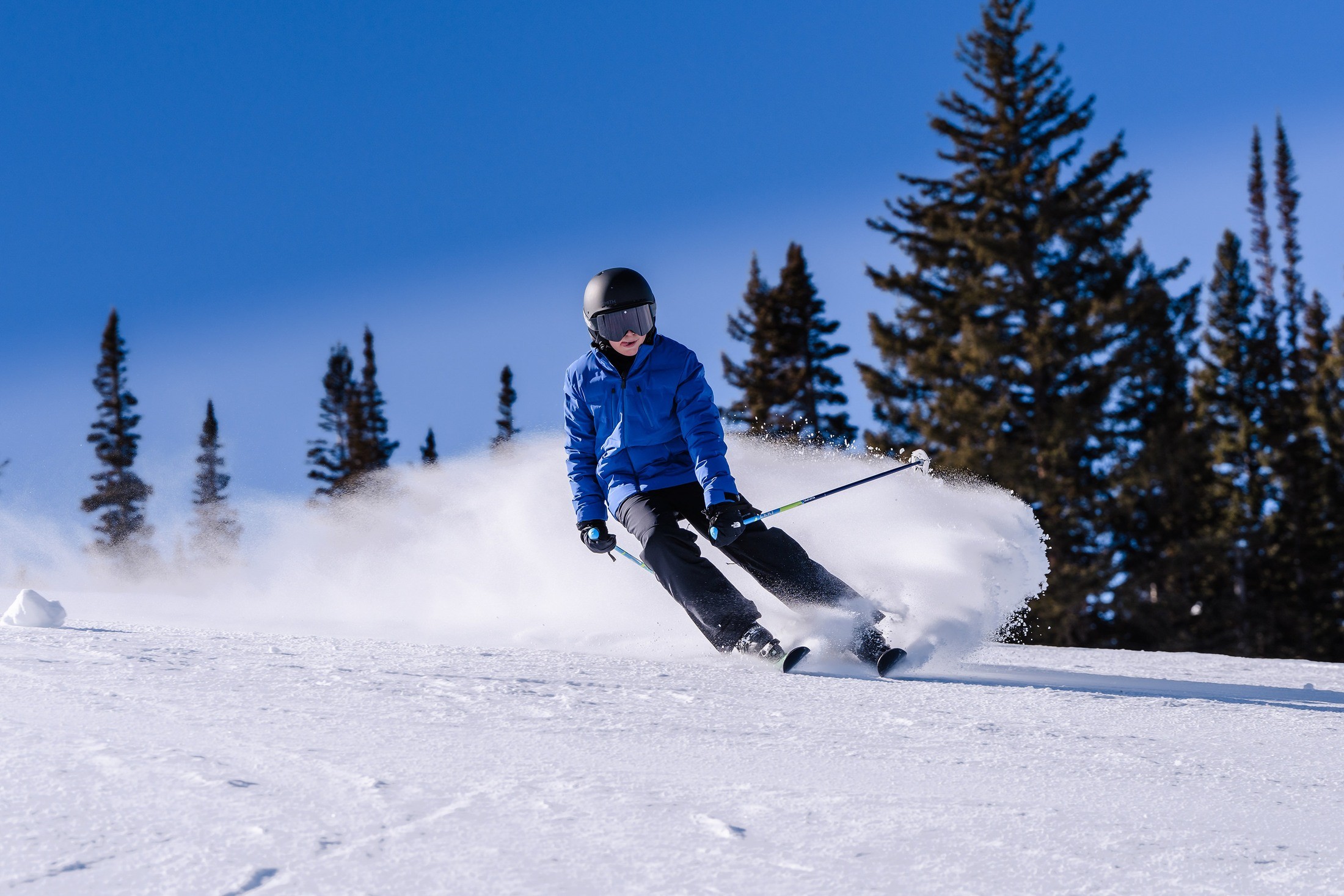 A young skier carving a turn during a bar mitzvah weekend in Aspen
