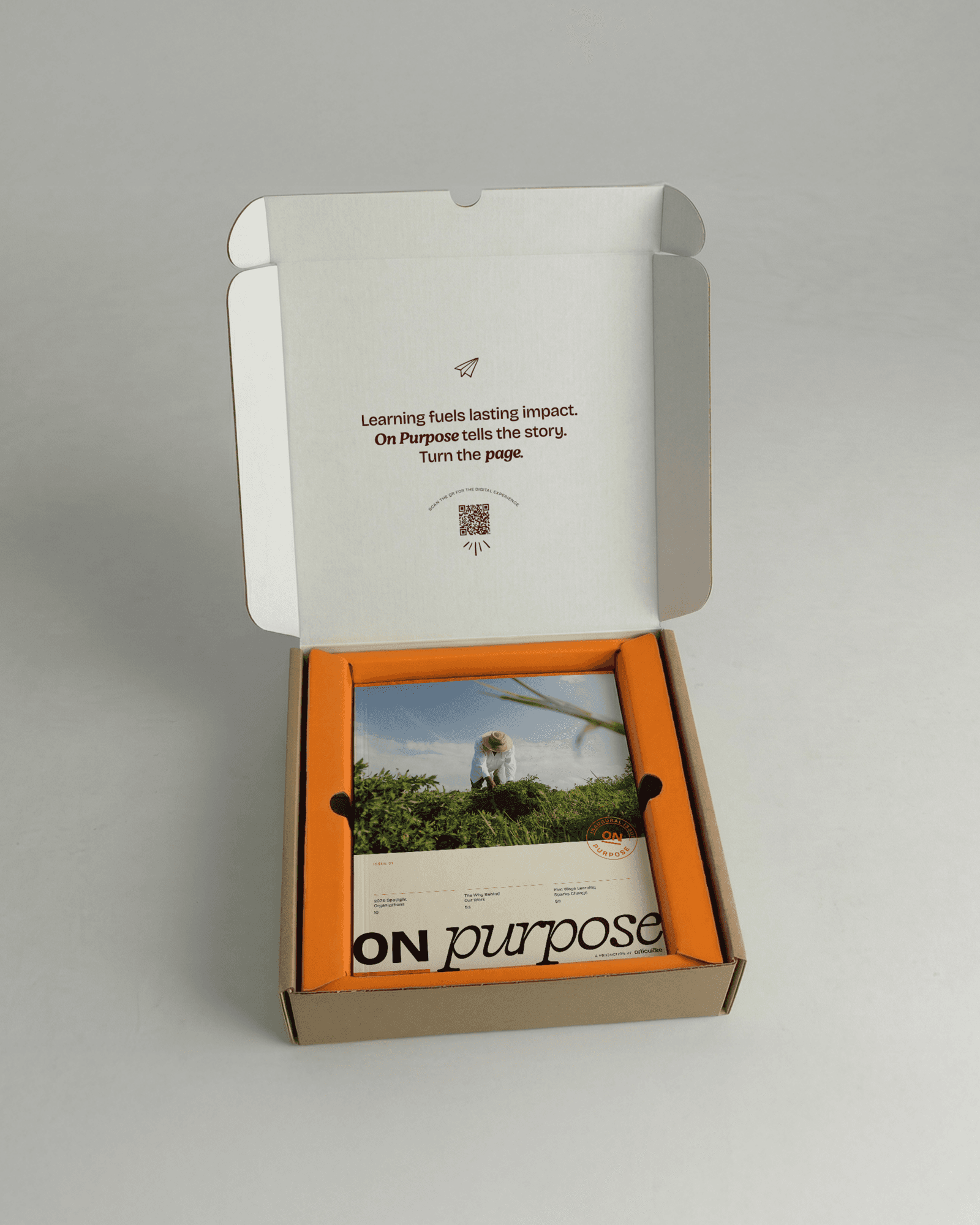 An opened On Purpose mailer box reveals the magazine and a card inviting recipients to scan a QR code for the digital experience.