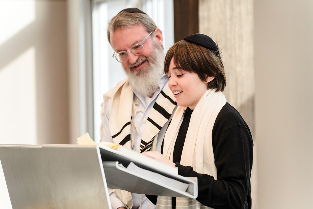 A young person reading during his bar mitzvah ceremony