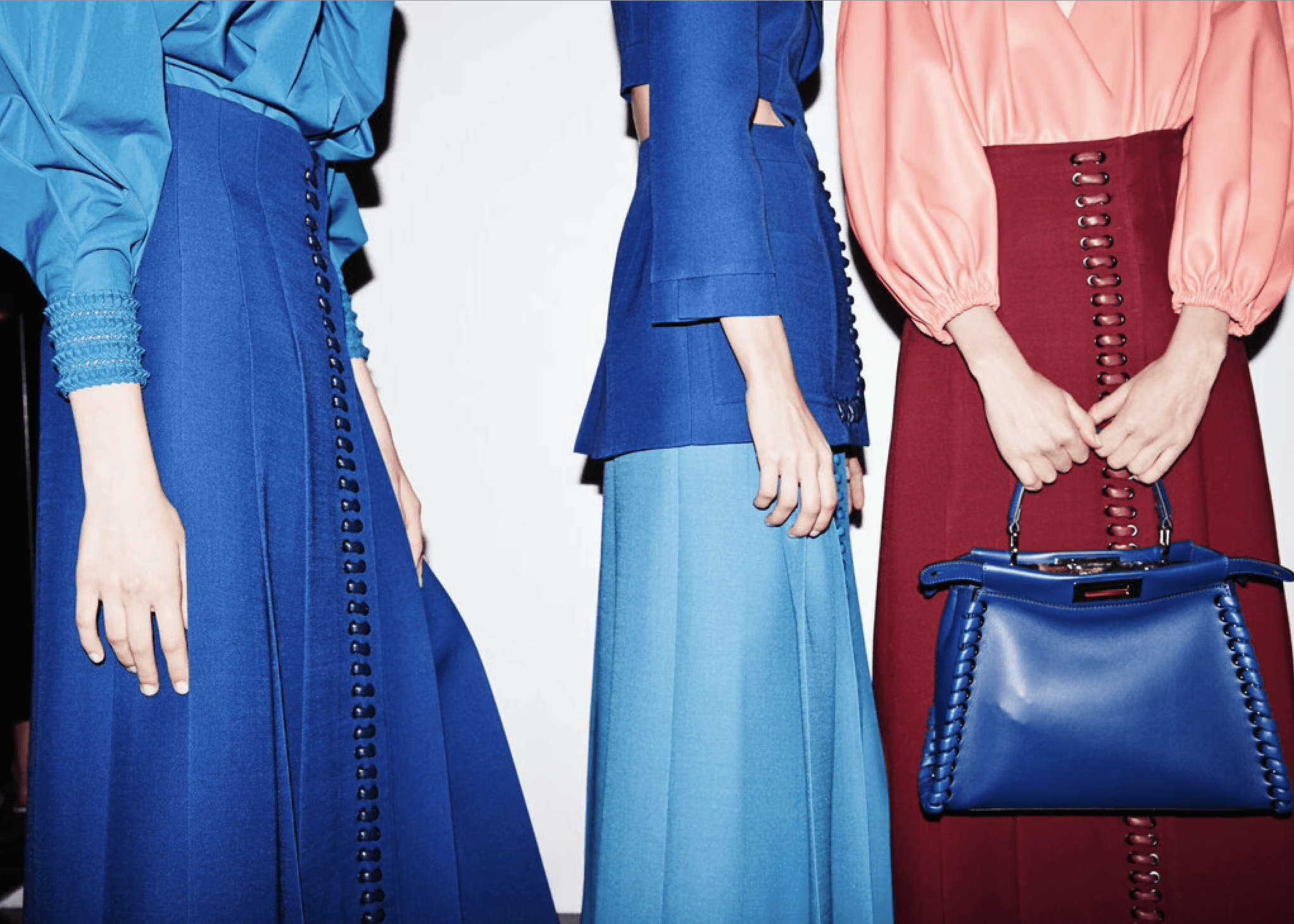 A fast black sports car races down the highway.