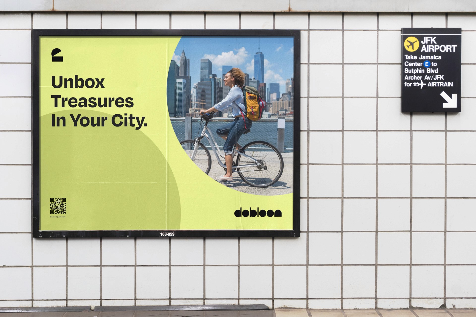 A billboard displays a yellow-green gradient background with the text "Unbox Treasures In Your City." A woman with a backpack rides a bicycle beside a body of water, with a city skyline visible in the background. A QR code is present in the bottom left corner. A black sign to the right reads “JFK AIRPORT” and includes directional arrows.