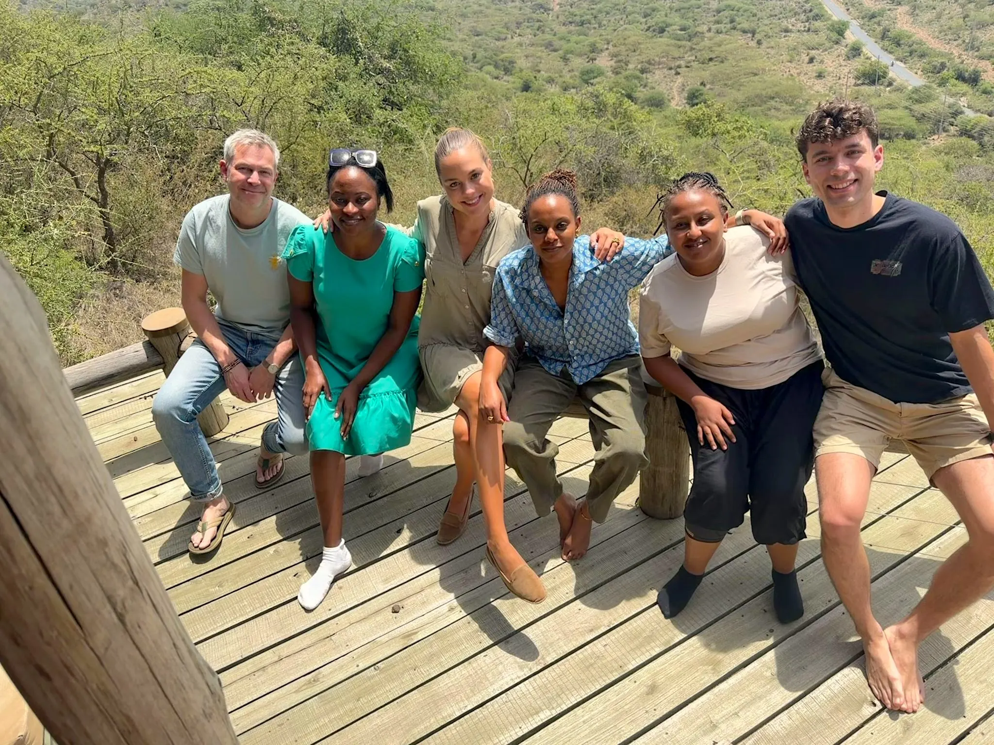 Group of Impacc team members smiling on a wooden dock
