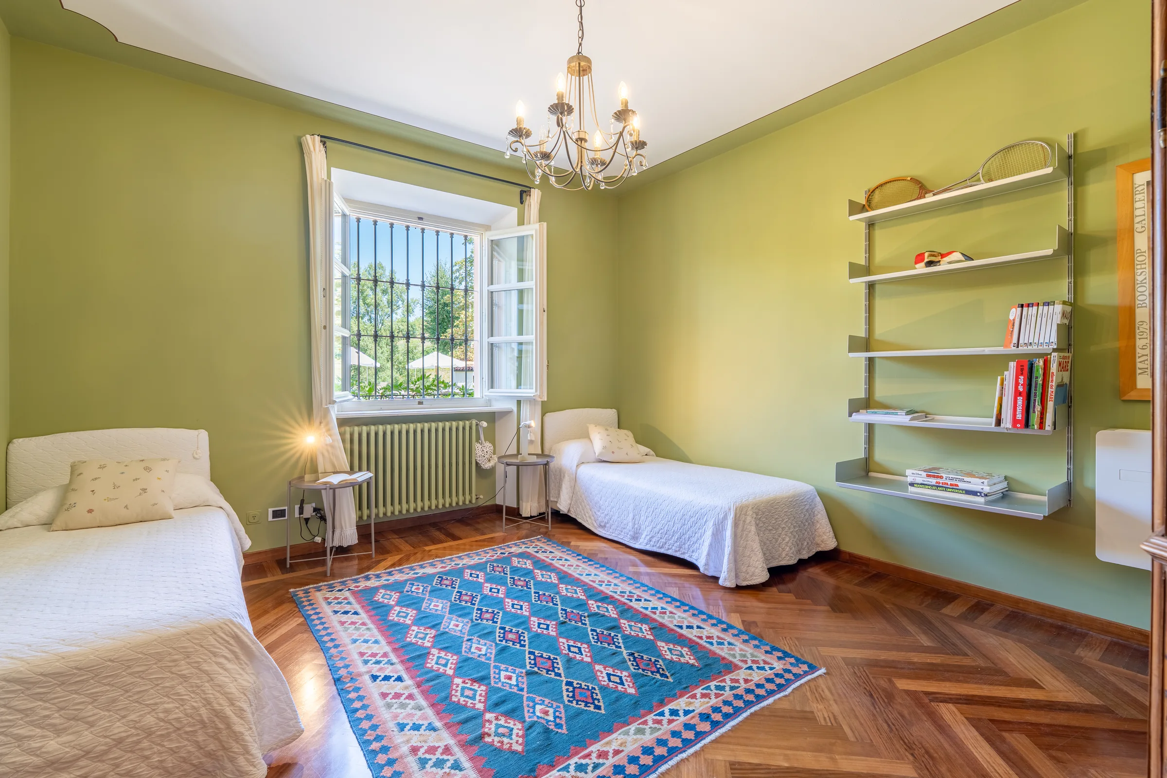 Twin bedroom with green details — Villa Ceva, Italy. Photography by Yunes Calore.