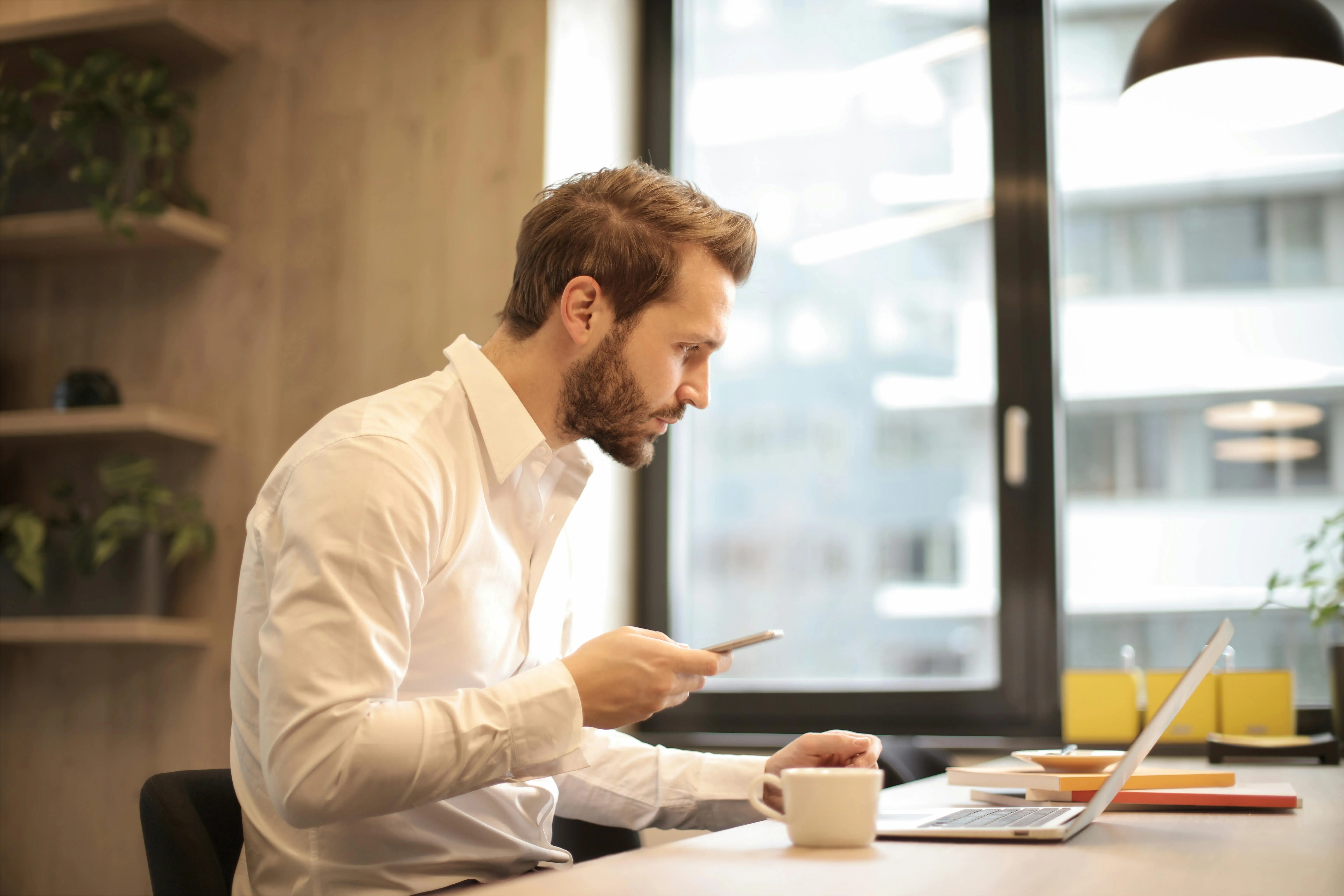 Professional expat deliberately managing his workload and priorities at his desk