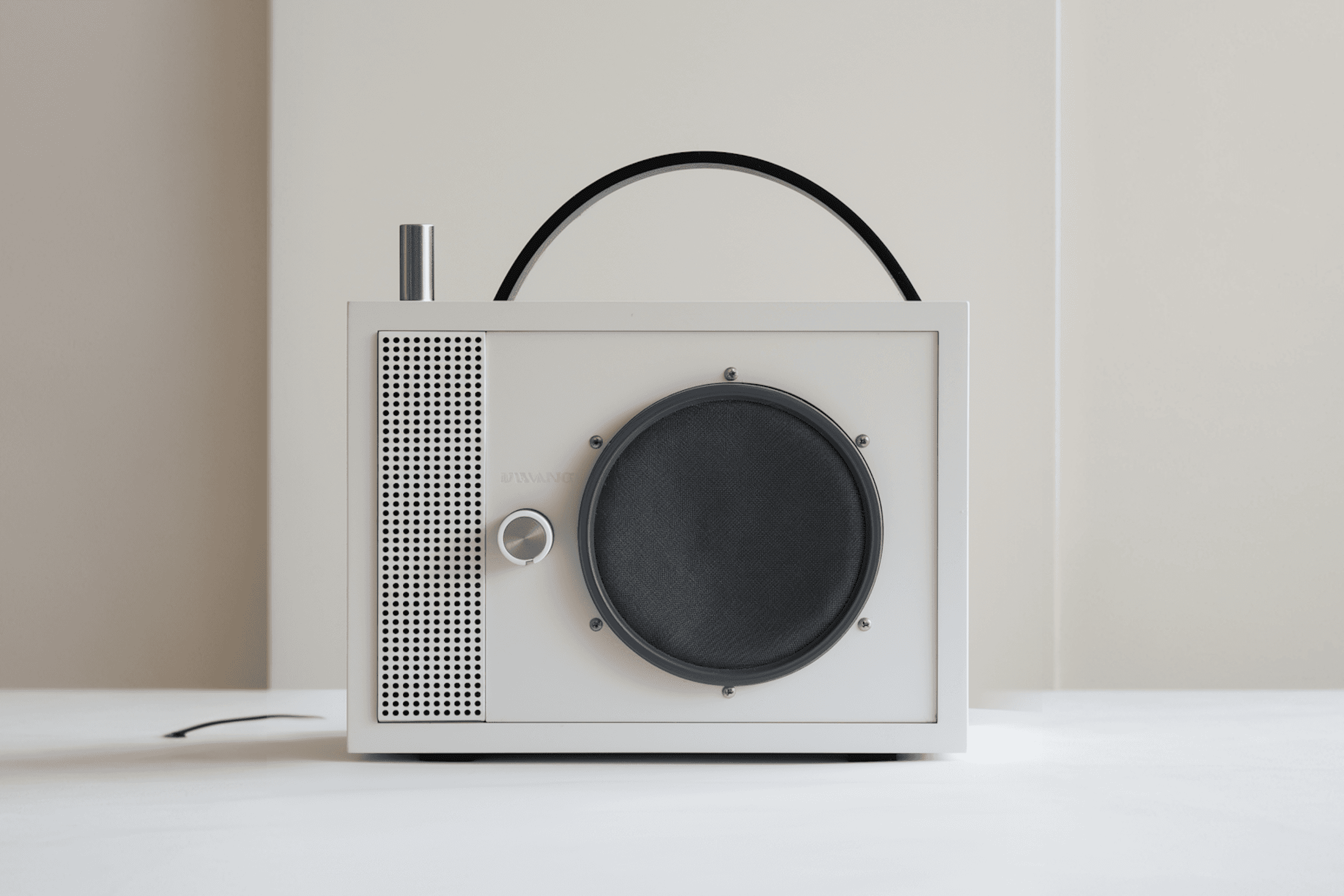 Minimalist retro-style radio with a sleek white design, large speaker, and black handle. Perfect for vintage and modern decor.