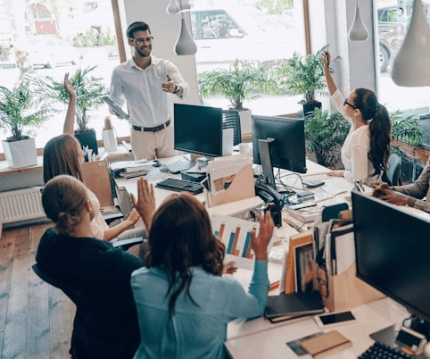 Young black woman witting at the table working on a laptop