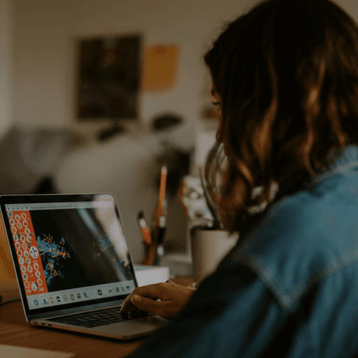 Trendy looking person using laptop from behind during day in cozy, modern home office