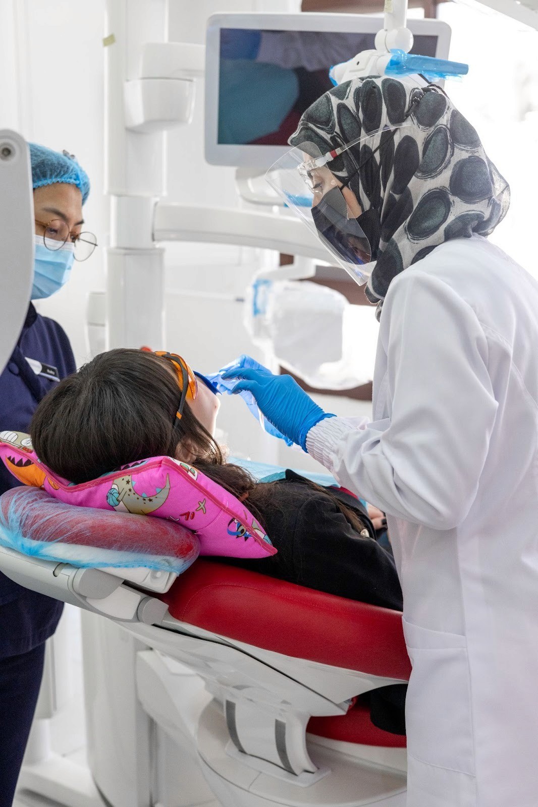 A dentist examining a patient’s teeth during a routine dental check-up.