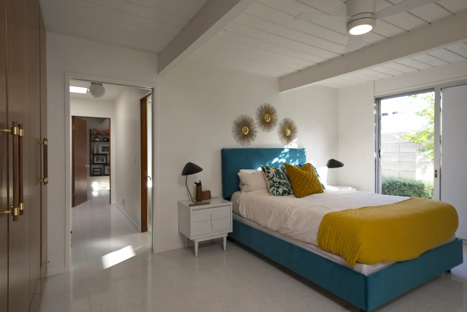 Expansive view of the primary bedroom suite, highlighting the room’s spaciousness and design in the Fairhaven Eichler Tract remodel. Photo by Todd Huge.