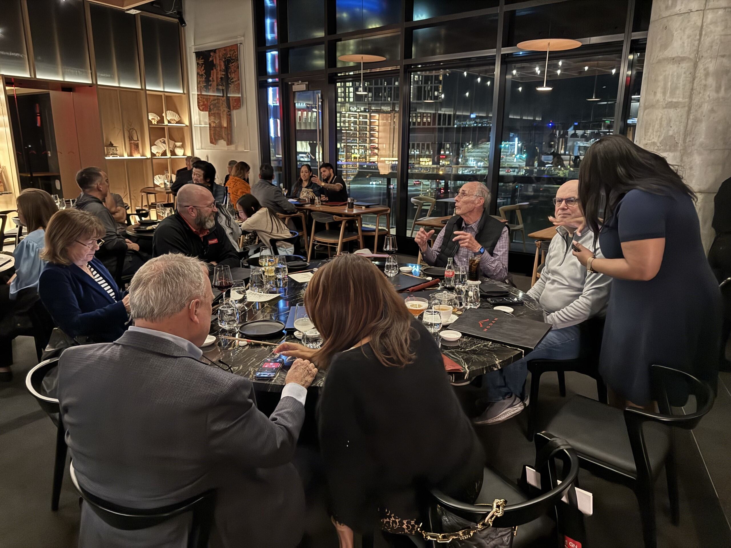 A man with short hair receives an ear examination from a medical professional wearing blue gloves.