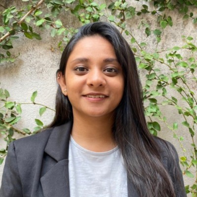 smiling woman standing while holding orange folder