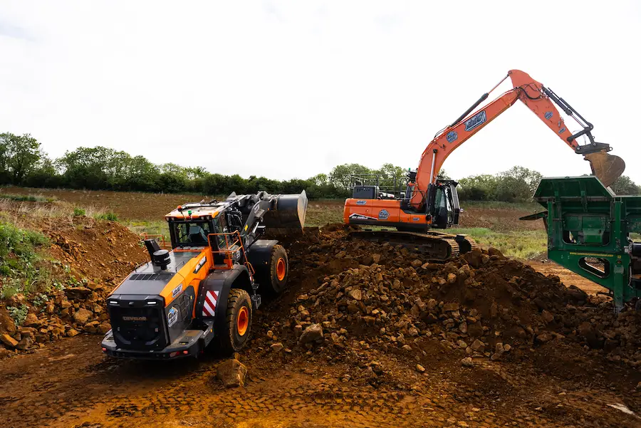 Excavator and loading shovel deployed on a construction site as part of heavy plant hire operations for bulk earthworks.