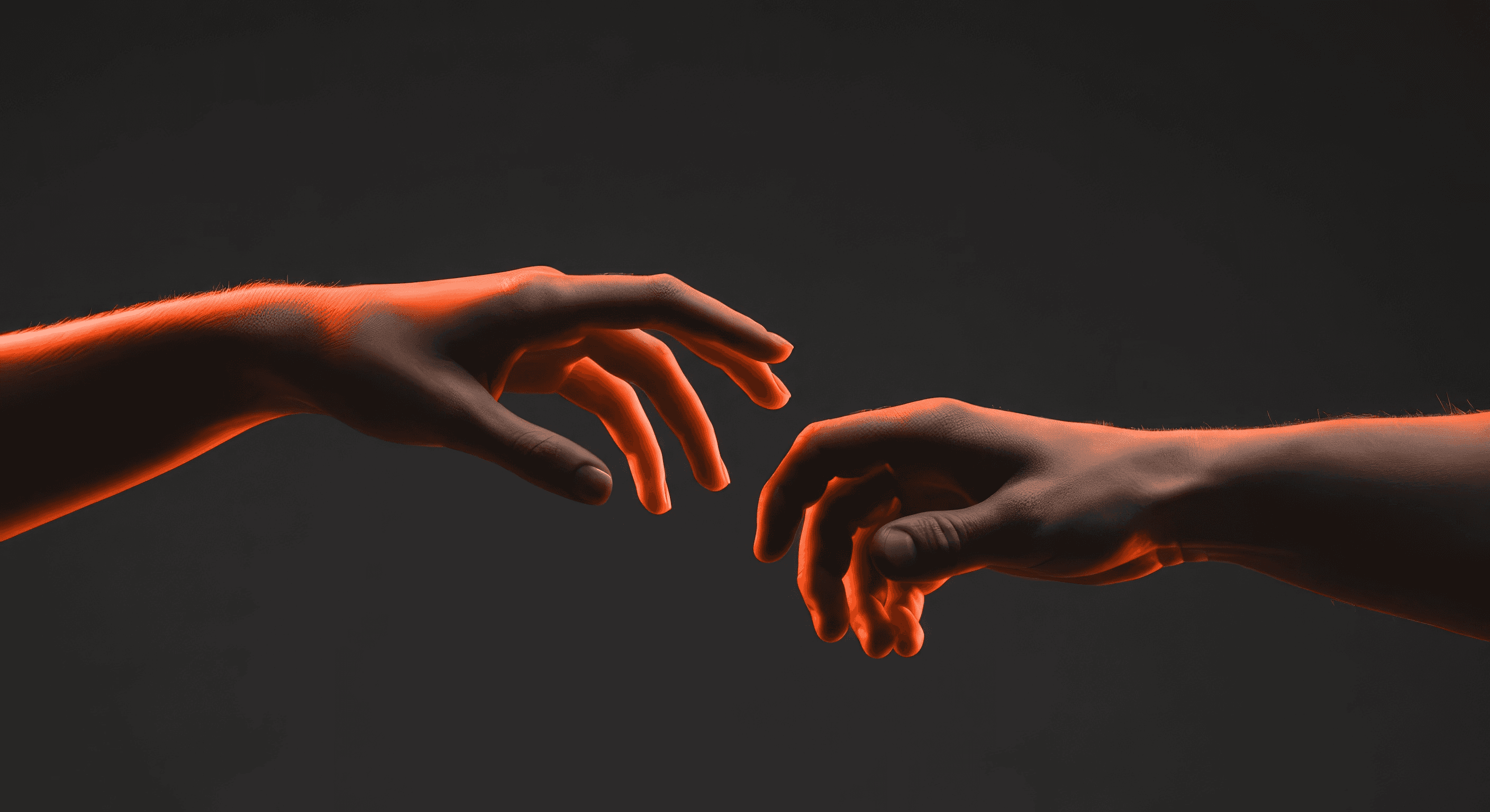 Two hands, one dark and one with an orange glow, reaching toward each other against a dark background.