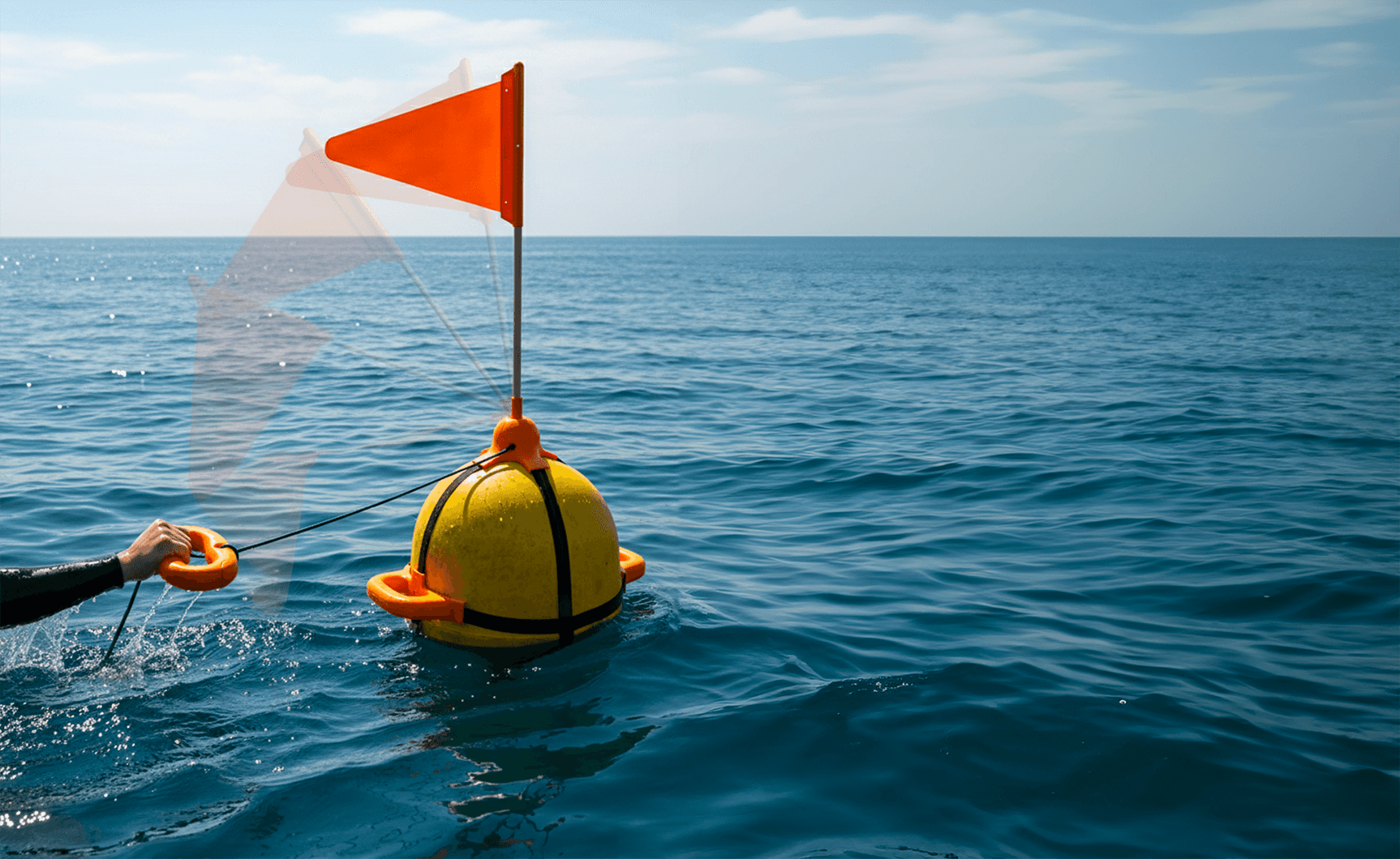 Conceptual rendering of the 'Rescue Buoy' in use, showing a person in distress using the handles to rest while the buoy's orange flag is raised for high-visibility signaling.