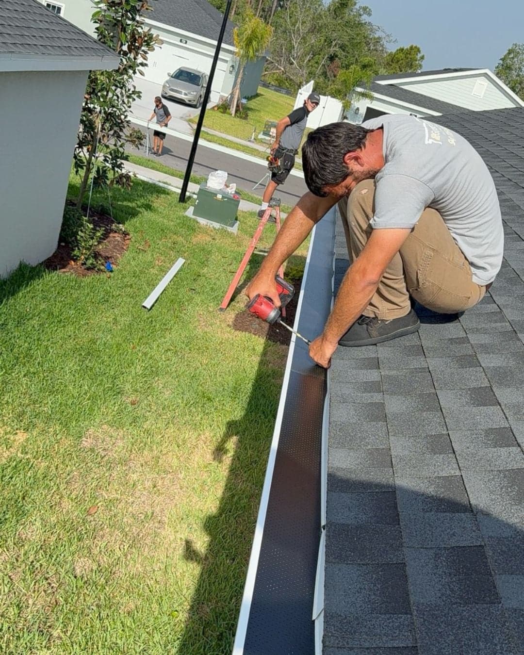 man on roof working on gutter bradenton