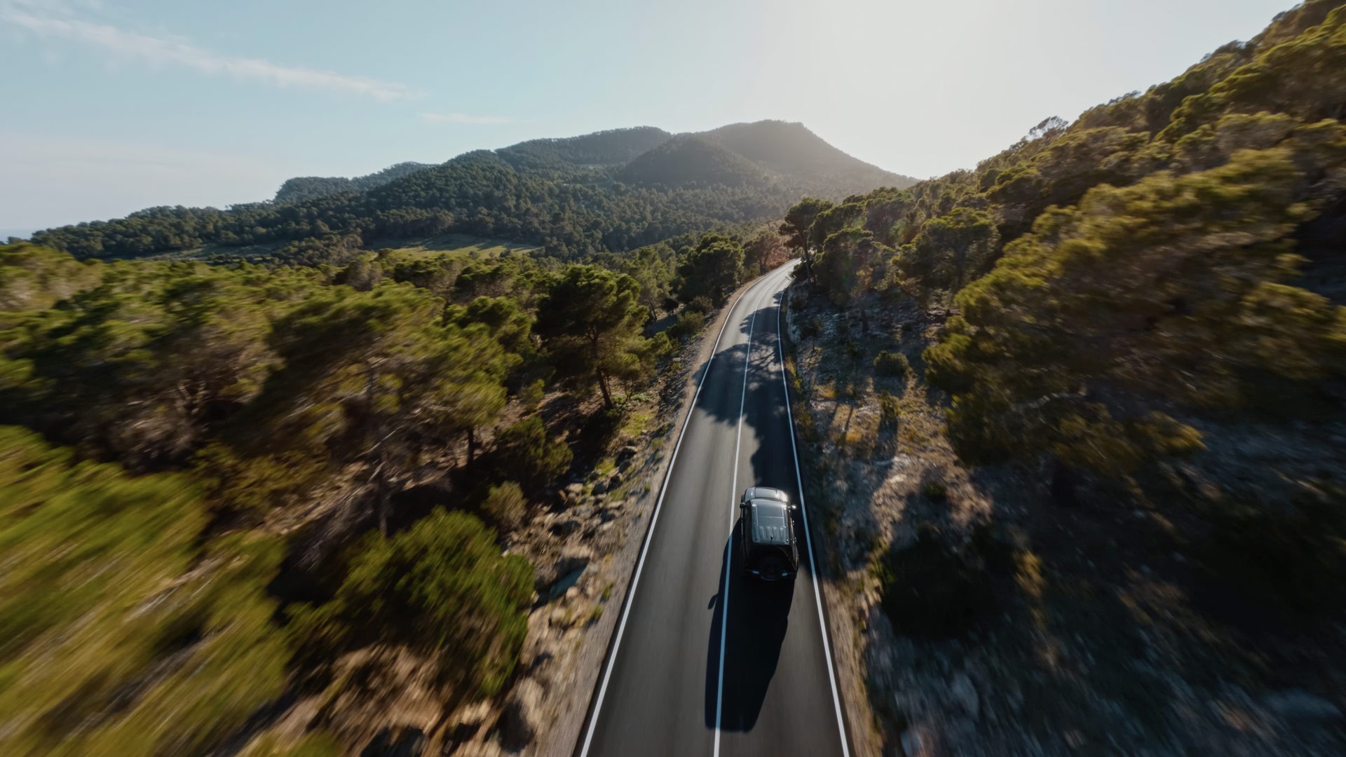 Car driving through Ibizas Landscape at golden hour