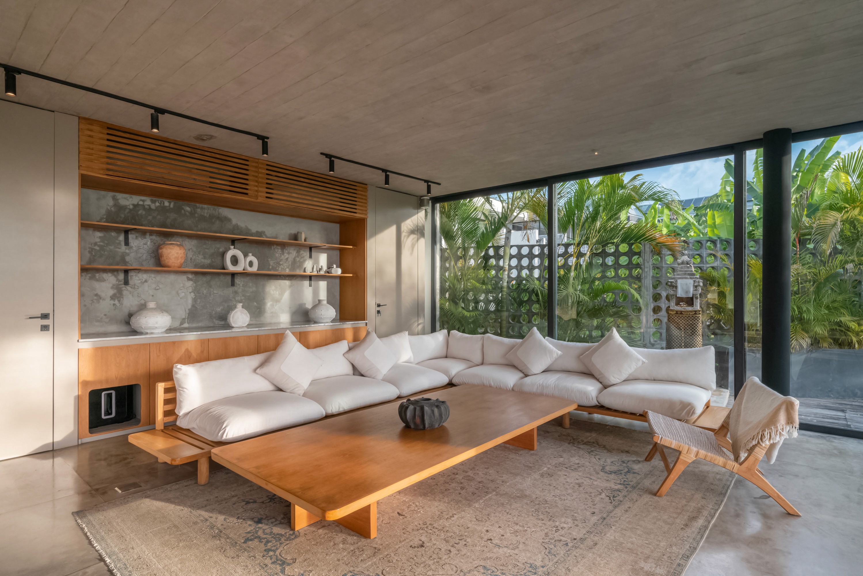 Gray sectional sofa with black coffee table and blue rug