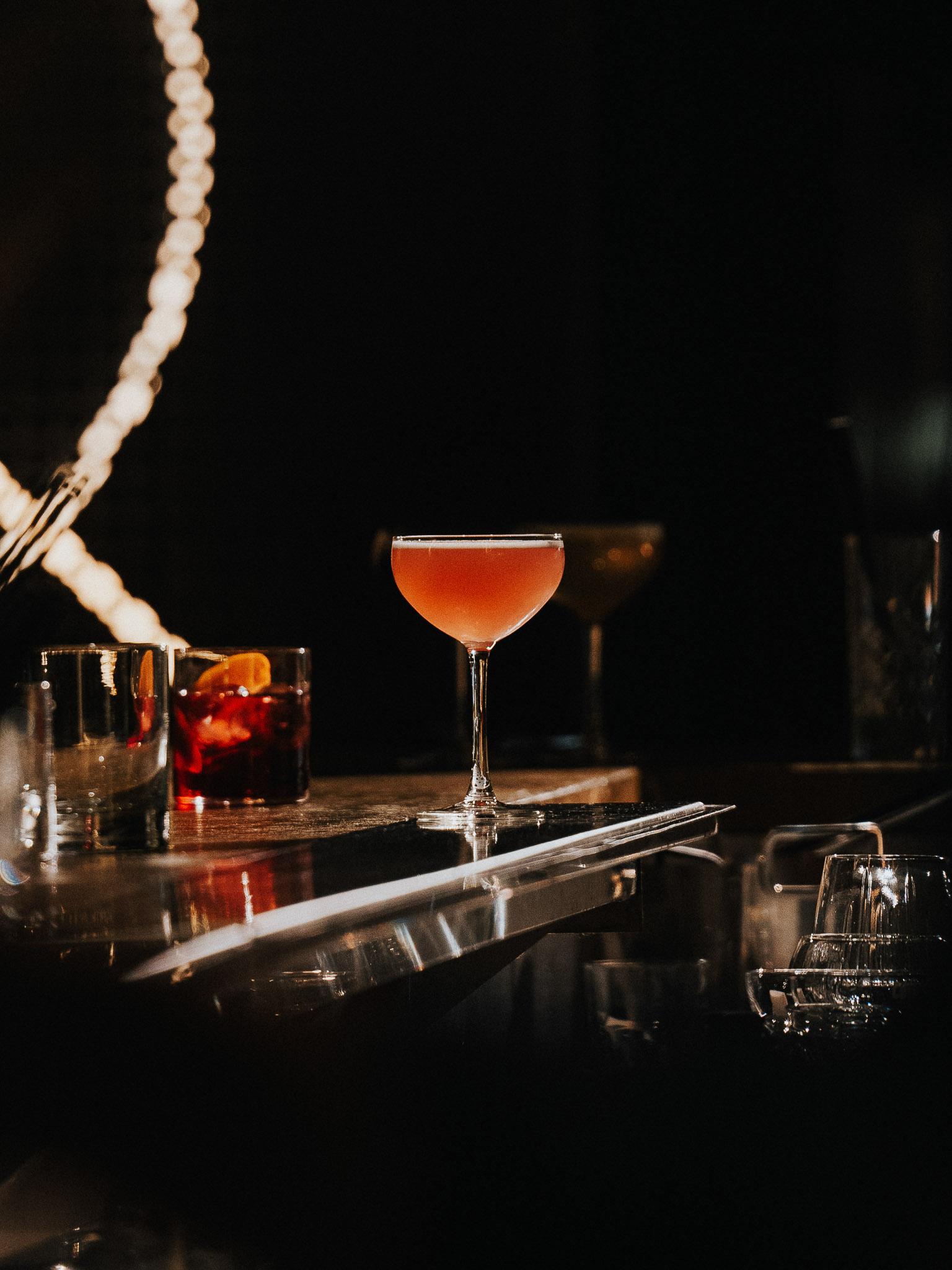 Freshly baked Margherita pizza with melted cheese, tomato sauce, and basil leaves, held by a person’s hand.