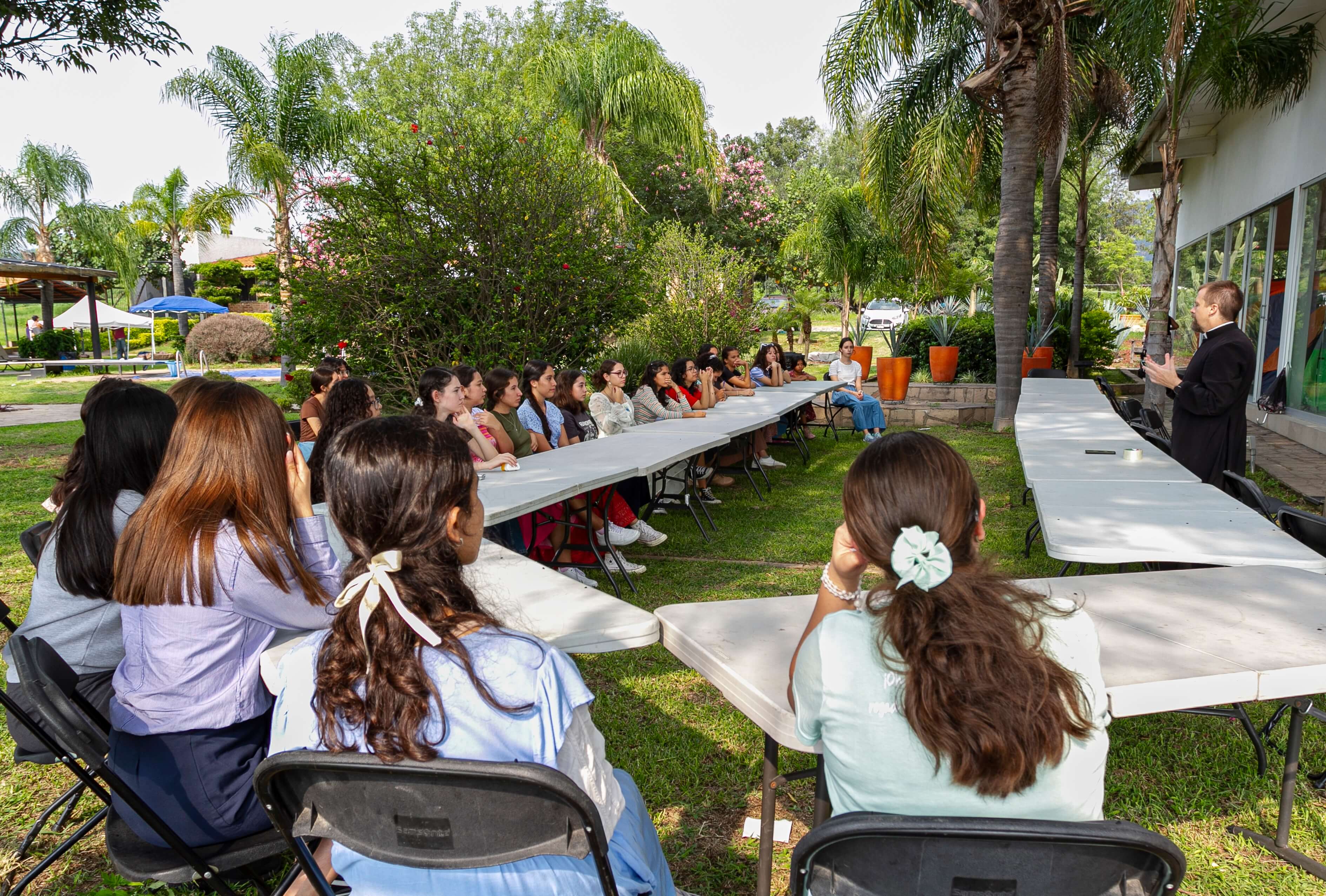 a group of children sitting on steps in front of a building