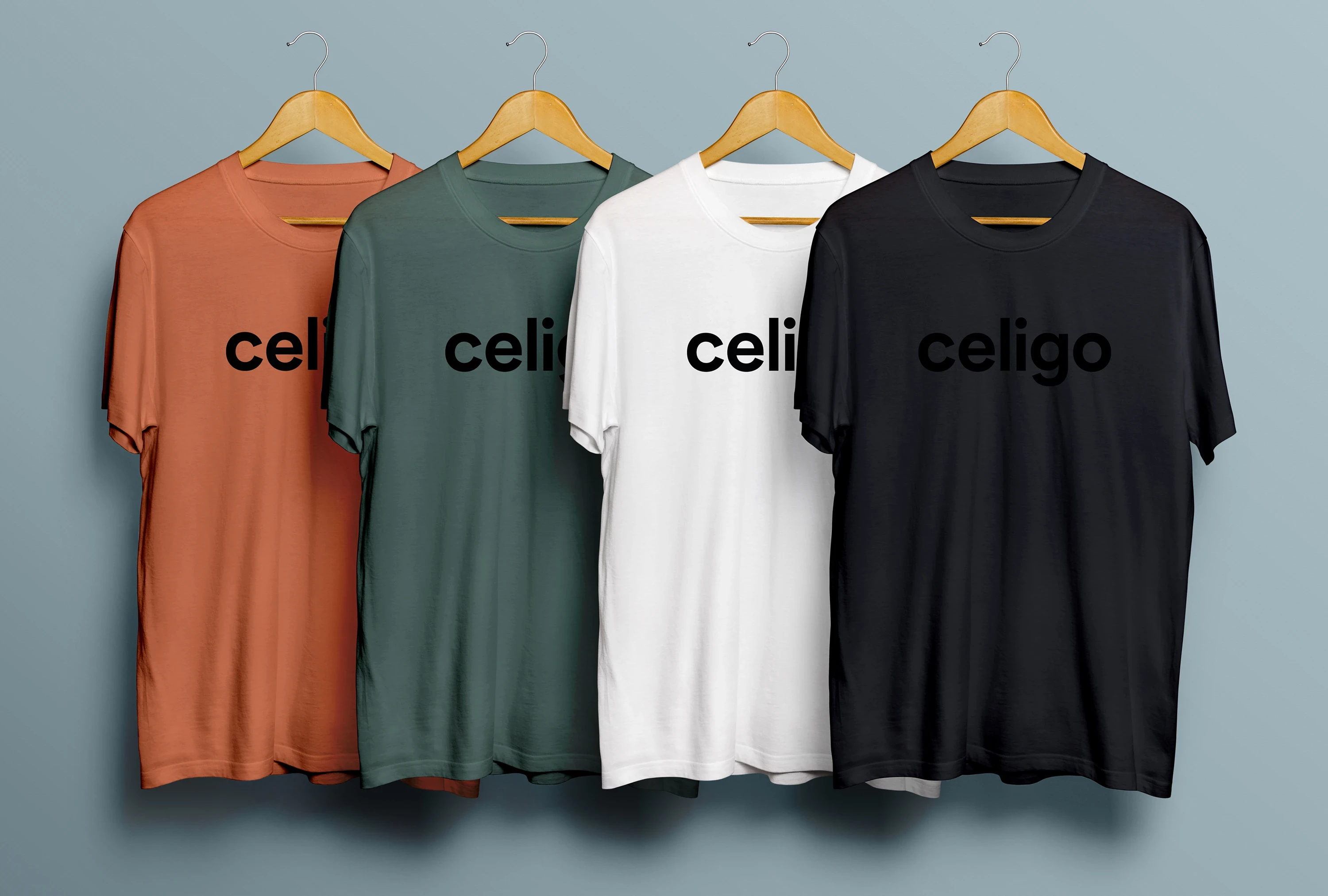 A photo of four t-shirts in brand colors with Celigo logo across the chest