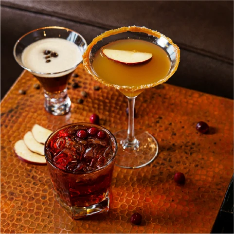 A cocktail is being passed between two hands.