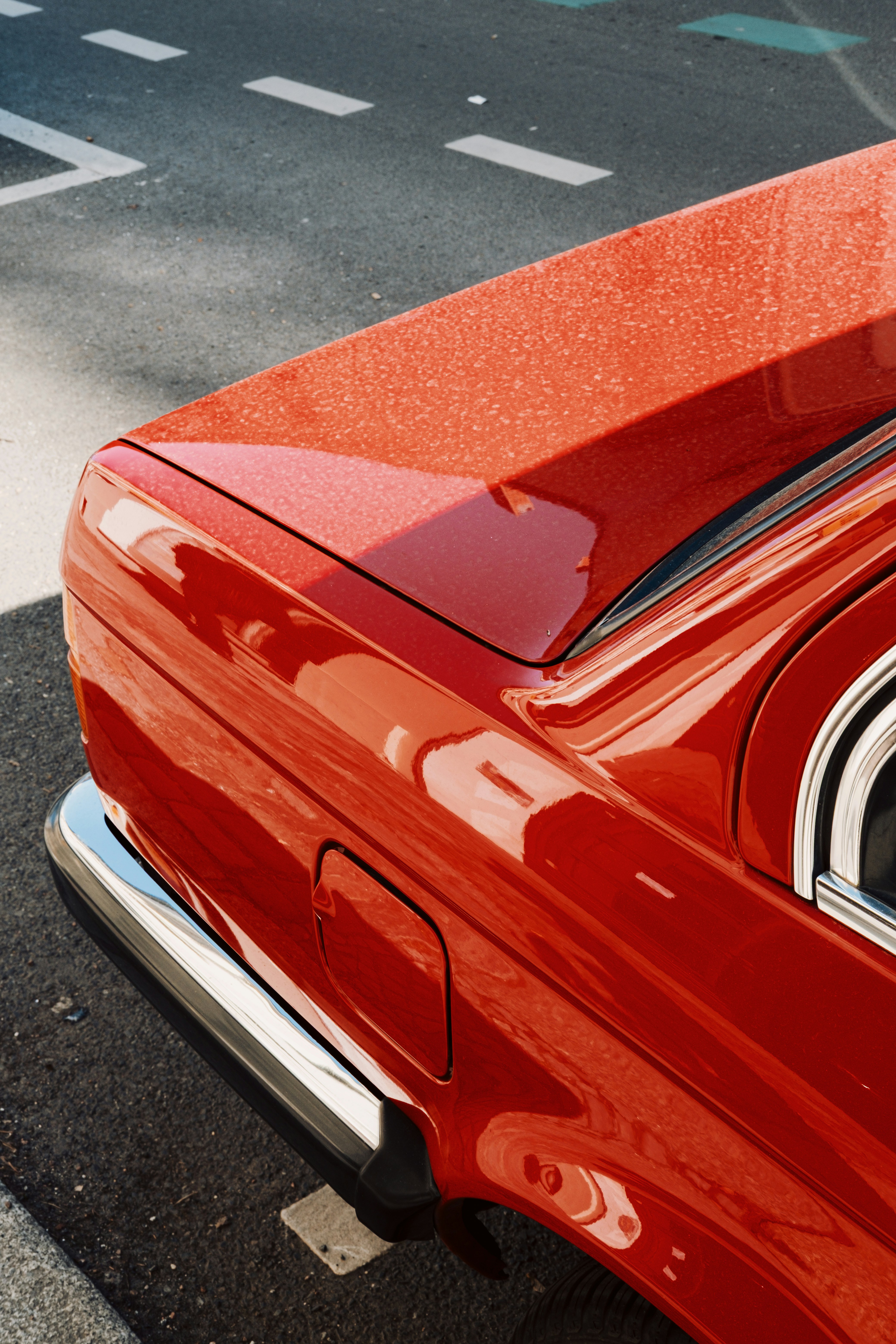 Close-up of a shiny red car trunk