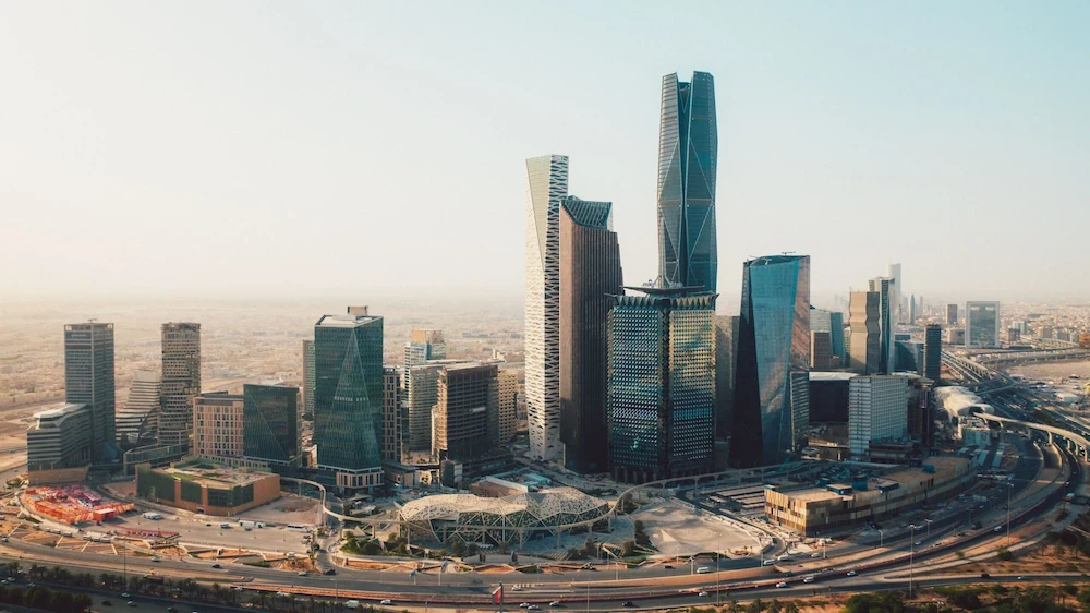 green chairs under umbrellas on shore