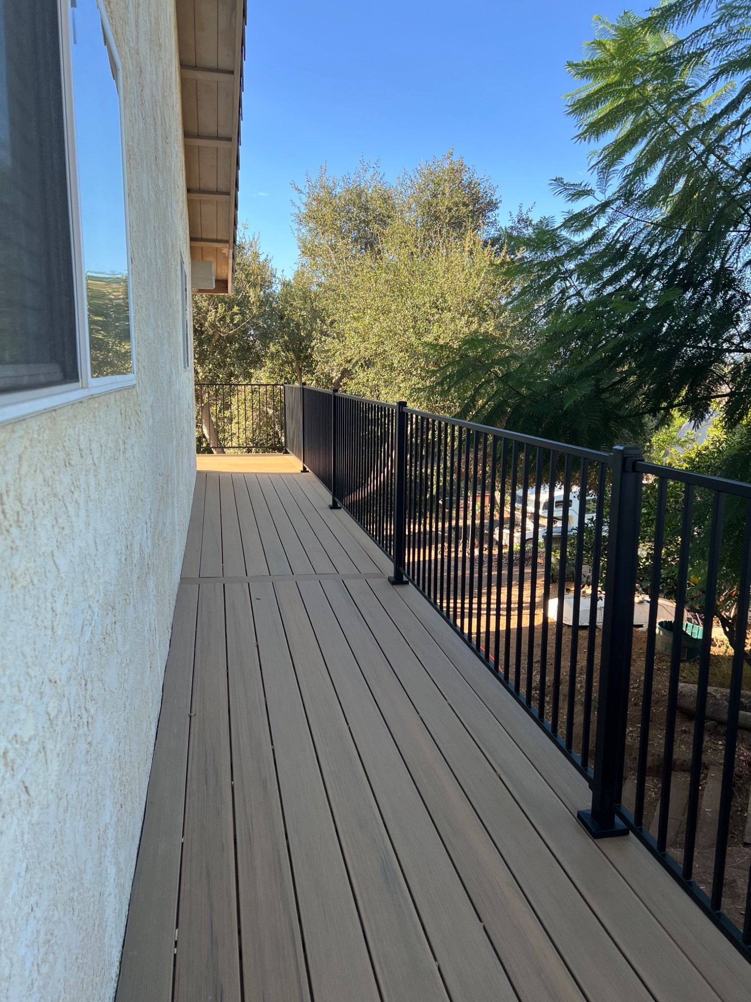 Escondido finished deck alternate view with TimberTech Coconut Husk decking and Trex Enhance black railing