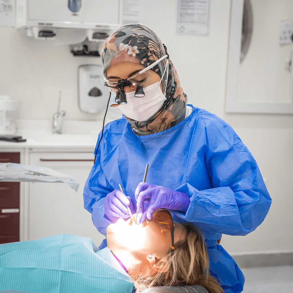 A dentist carrying out a detailed dental procedure.