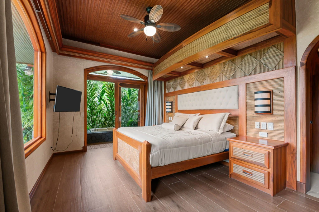 A bedroom with access to an outdoor bath in a villa