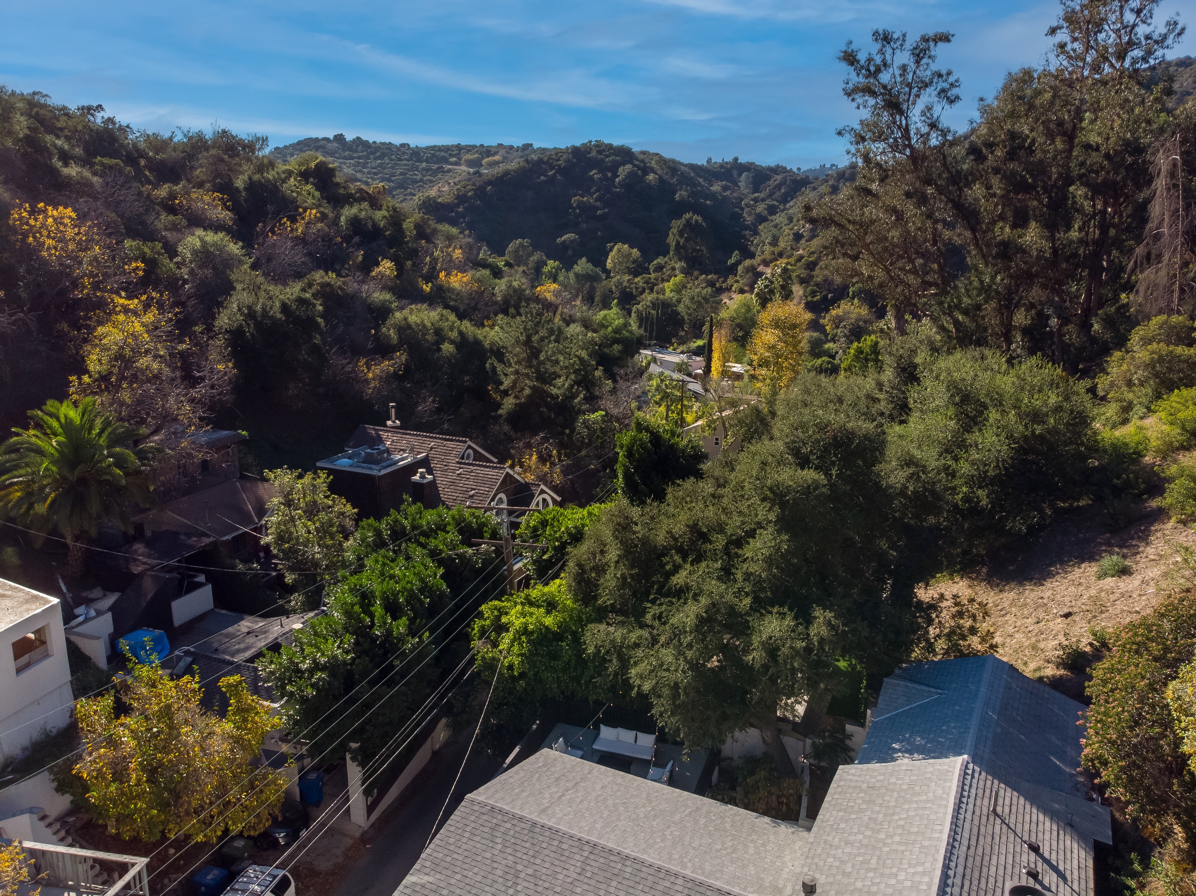 Wooden bench overlooking forested hills and a lake