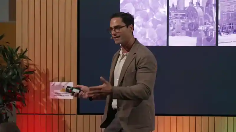 Speaker presenting on the plenary stage at the L&G Retail Tech Summit, using on-screen visuals to support a keynote session.