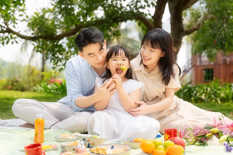 Family enjoying a relaxed daytime picnic session on Sunday