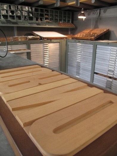 A photo of some wood carved letters used on printing presses.