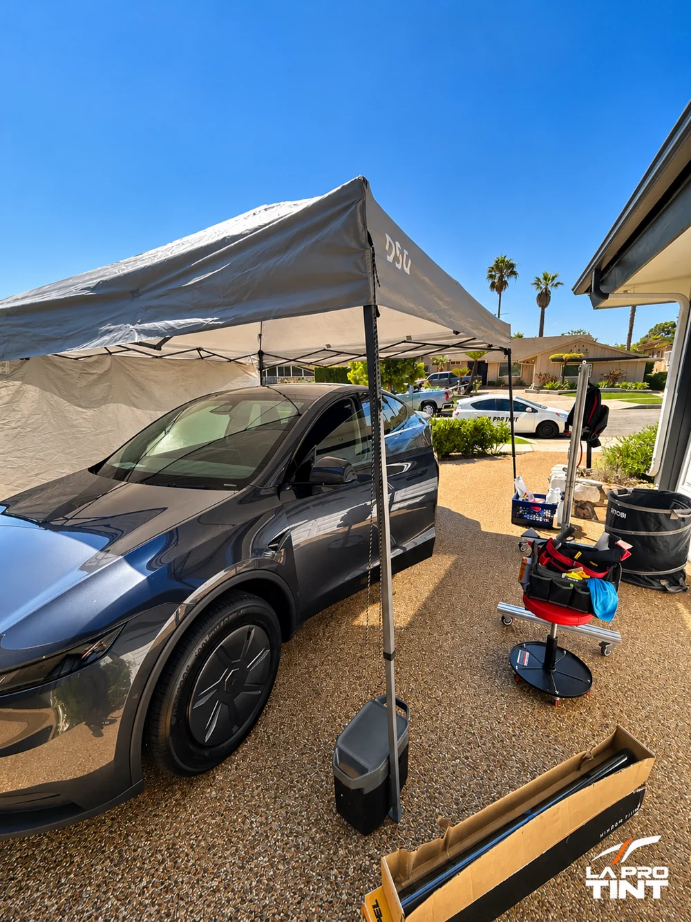 Mobile canopy beside a Tesla