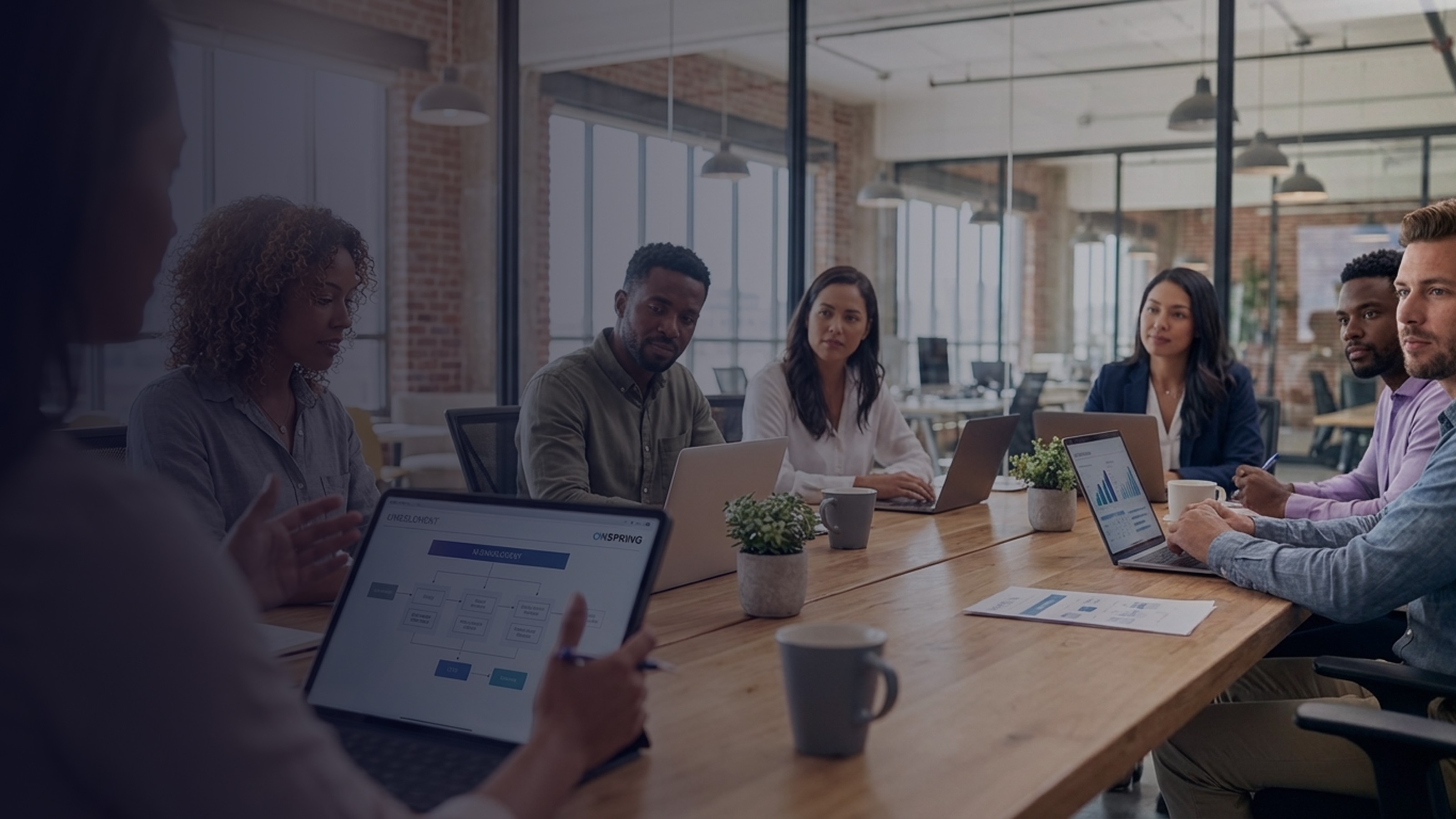 Creative tech worker in a cyberpunk setting with bi-directional blue and purple light against a blurred background. 