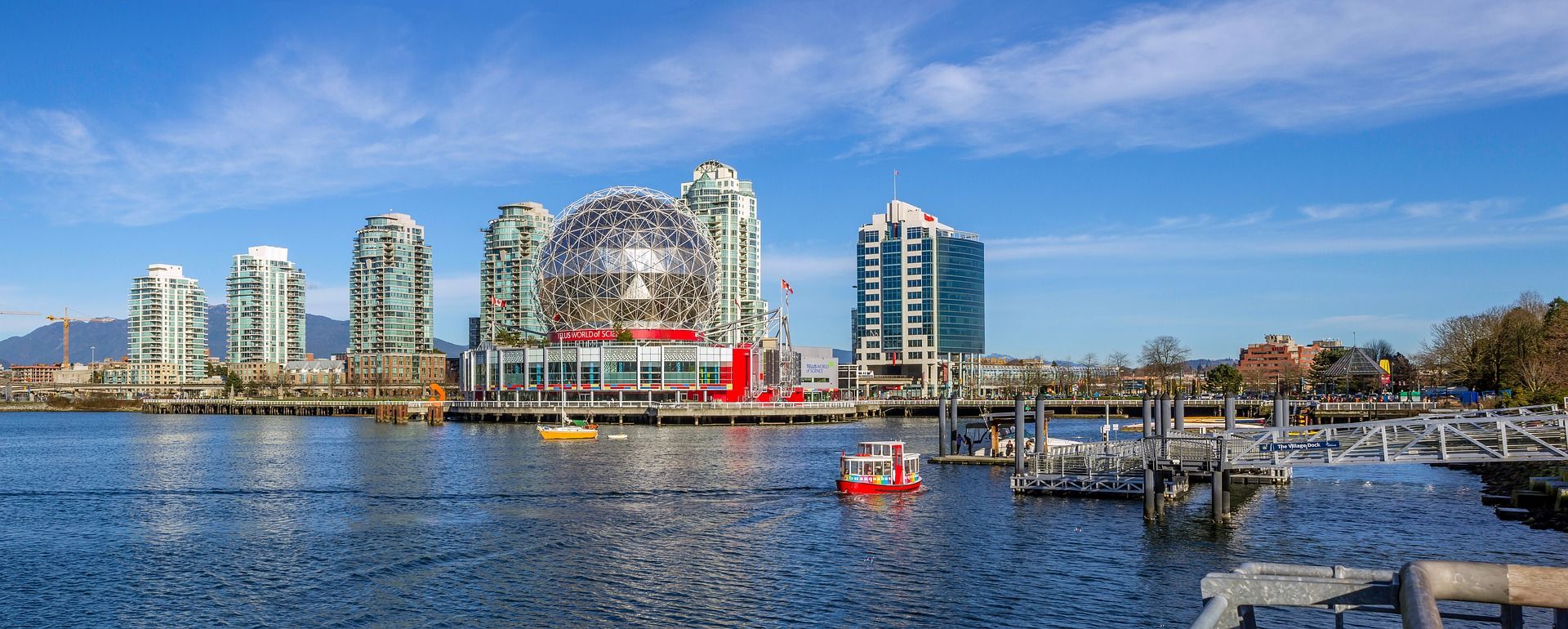 Science World geodesic dome and other buildings by the water in Vancouver