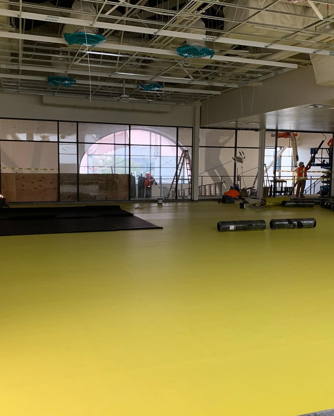 Acoustic mat covering the floor before rubber tile installation