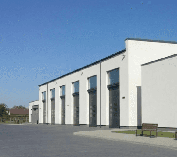 Exterior of a building with orange awnings and a sign above the door that reads “Prospect.”