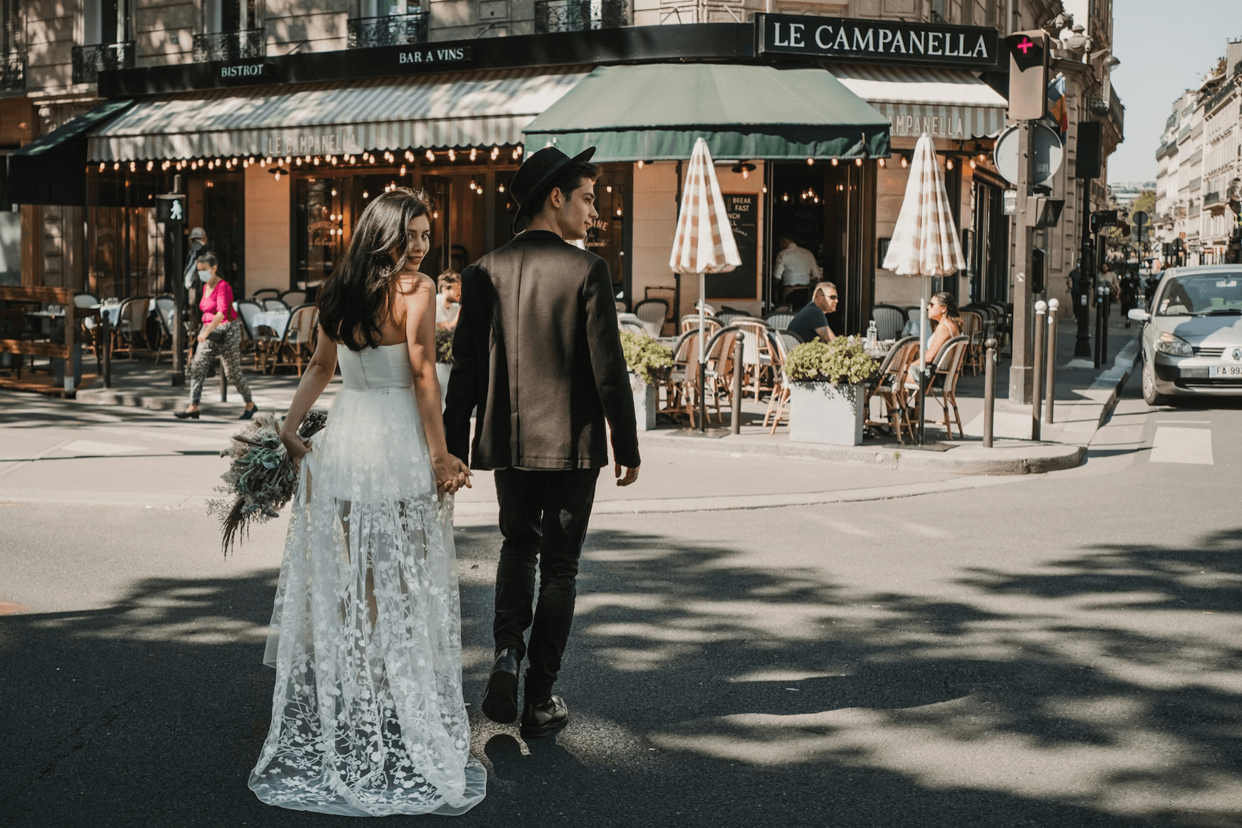 Wedding couple holding hands while walking in Paris streets for an elopement