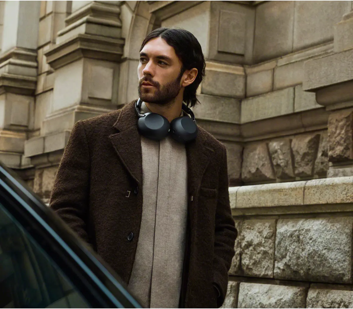 Man walking with black headphones around neck