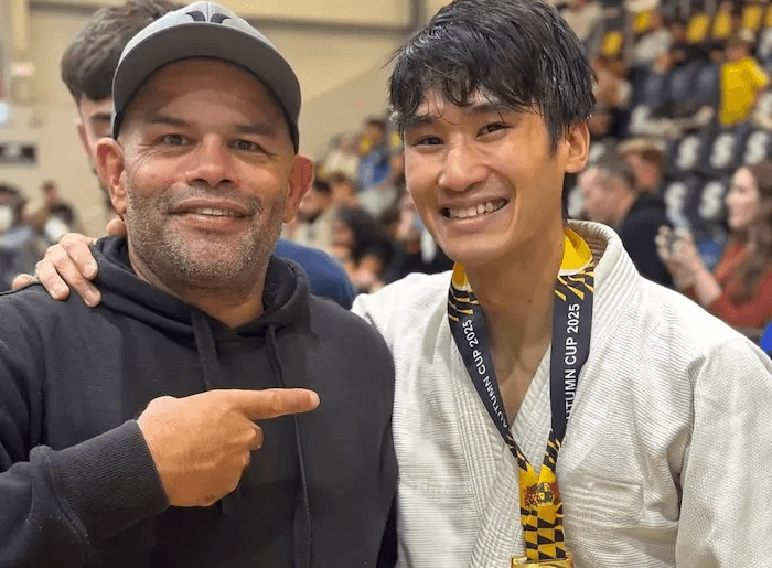 Coach and young athlete with a gold medal