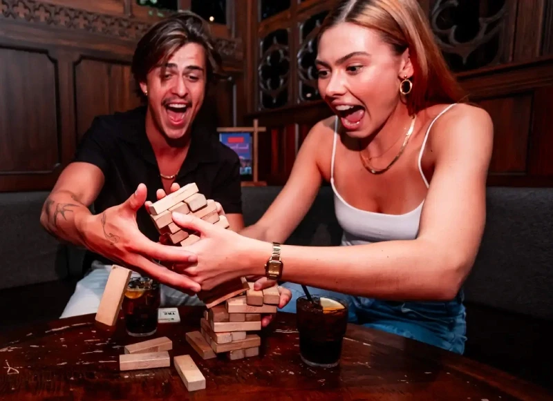 Young Couple playing Jenga in the Tavern at Fortress