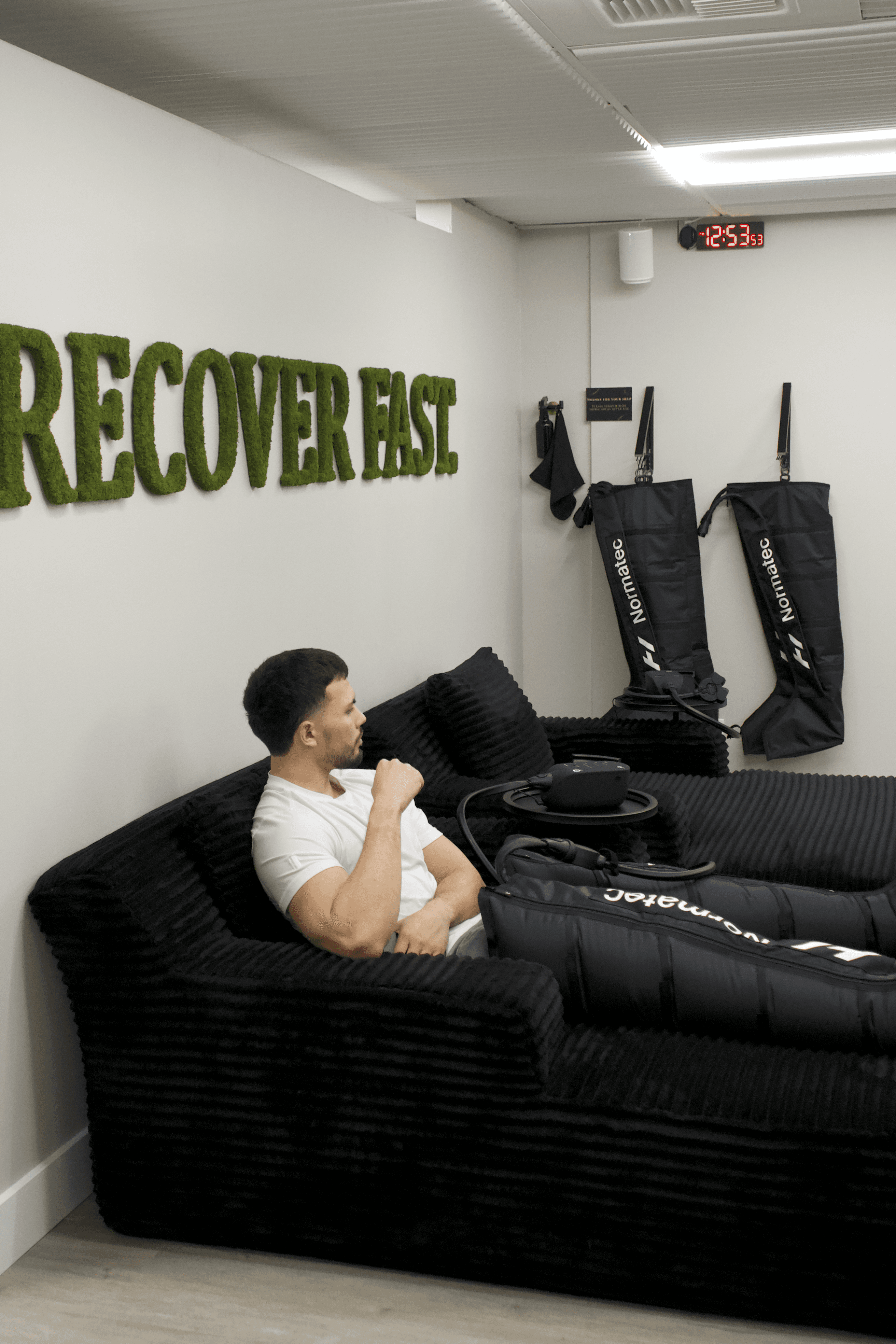 A skincare tube placed on dark, moss-covered rocks, surrounded by a natural, earthy backdrop.