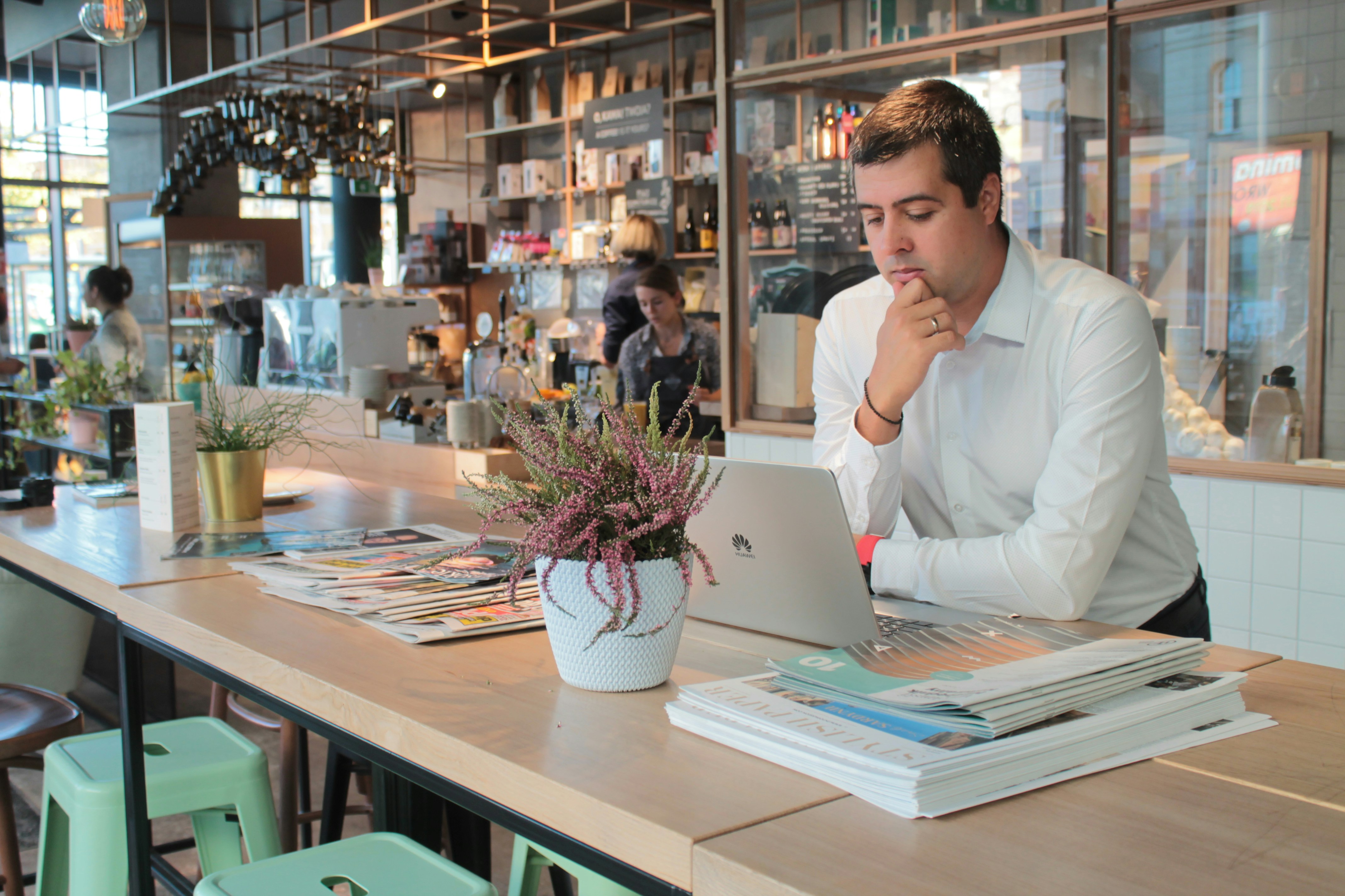 man in white dress shirt sitting at the table