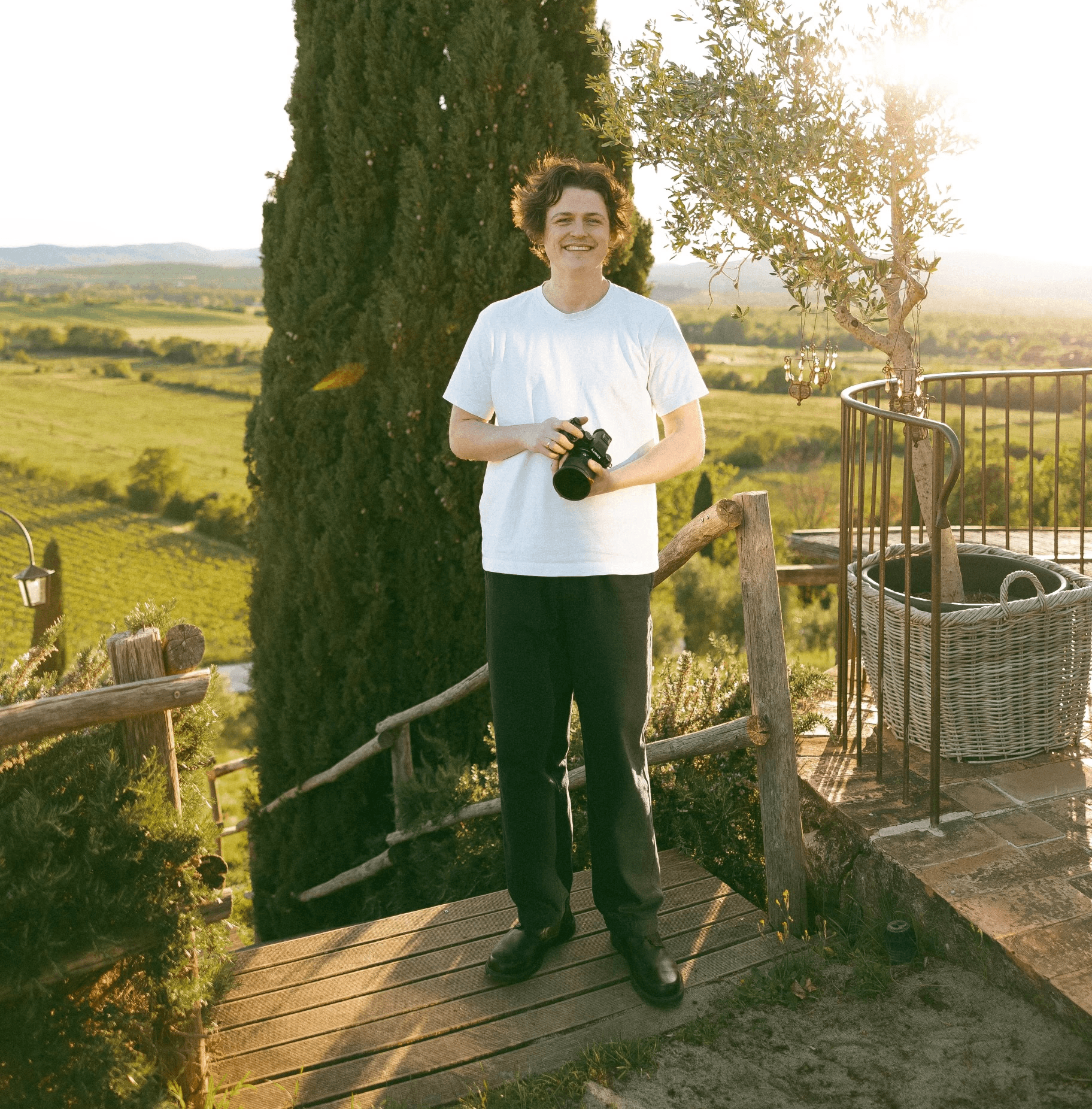 Wedding videographer standing outdoors in Italy during golden hour